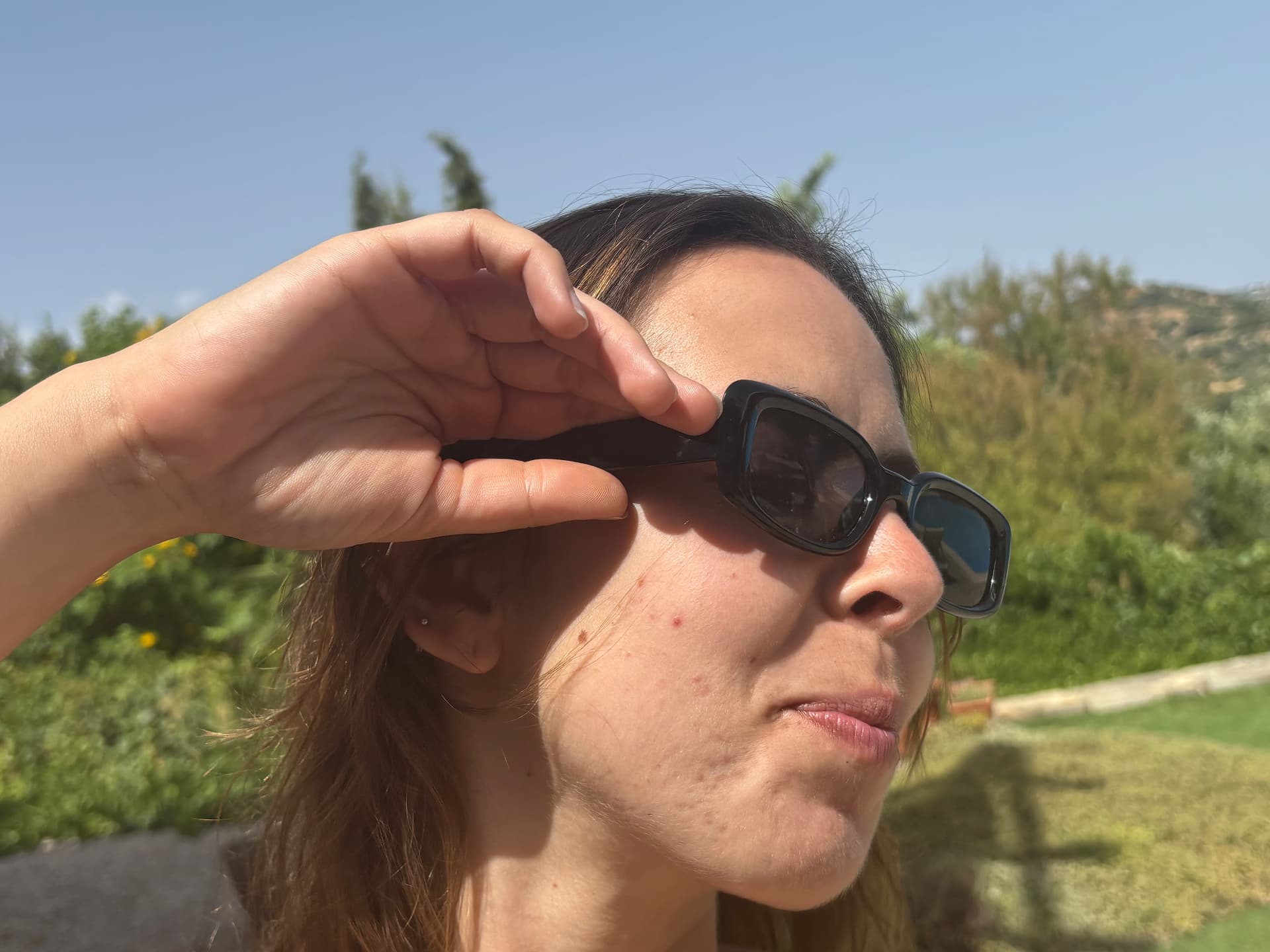 Woman shielding her eyes wearing the frame