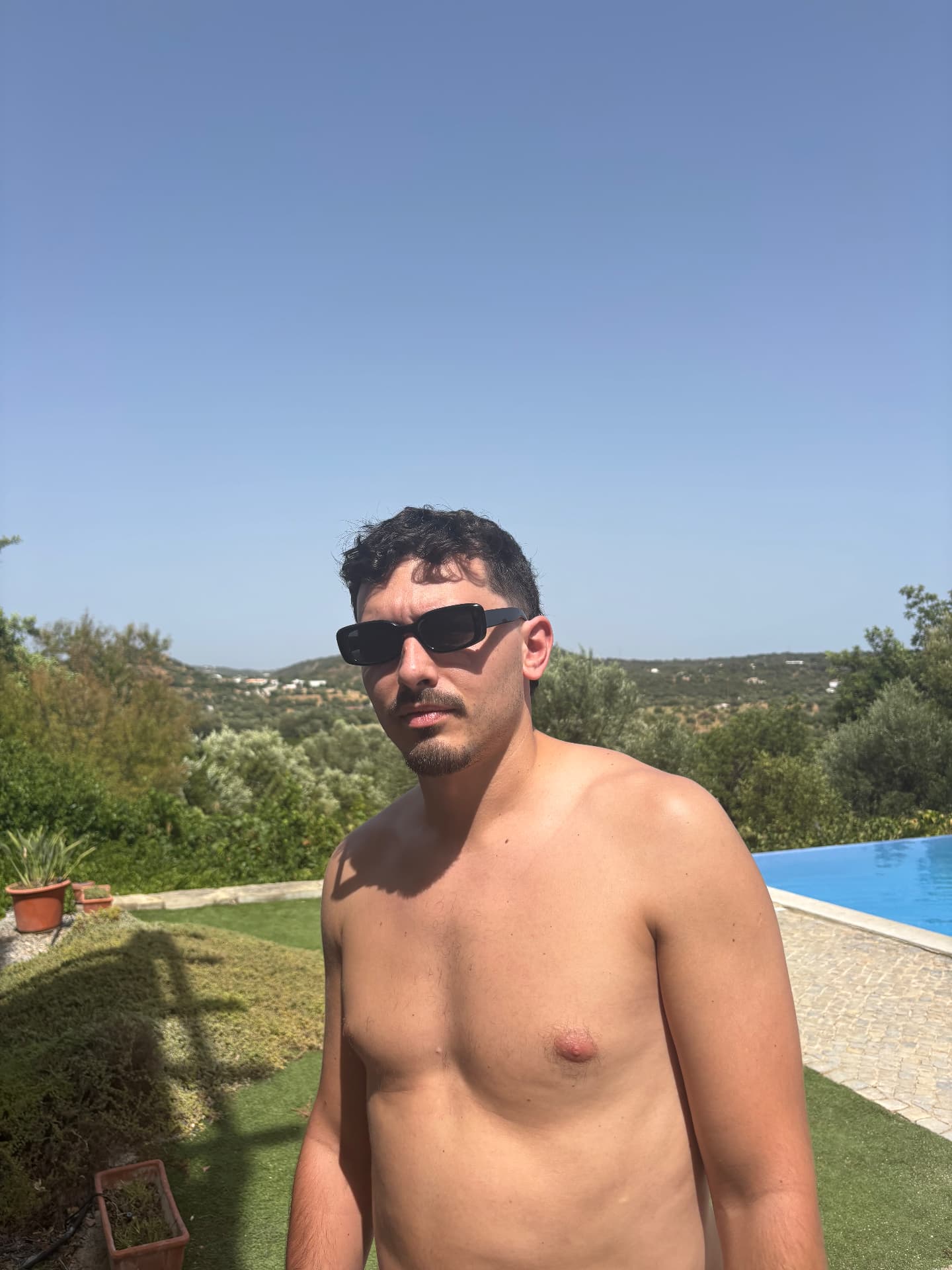 Man in the sunglasses with hills behind him