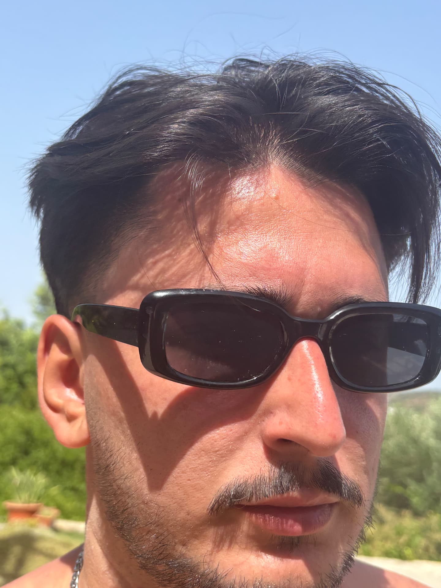 Man wearing the unmarked Obsidian No.1 sunglasses in strong sunlight
